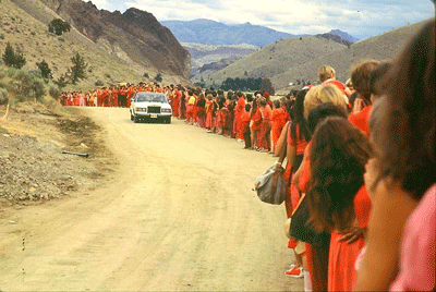 Rajneesh driving by his followers