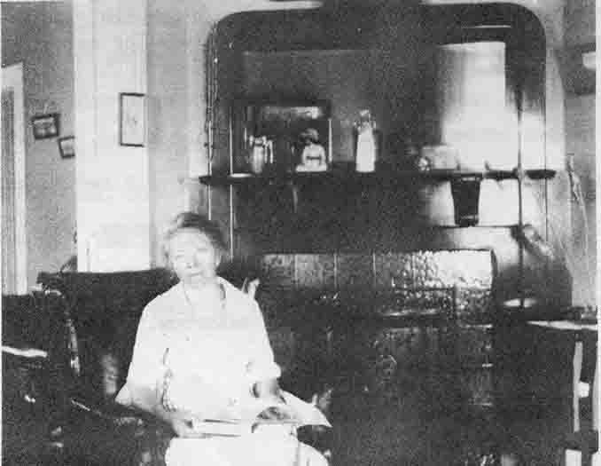 Jenny DeRoy sitting in front of the fireplace in the Keeper's House